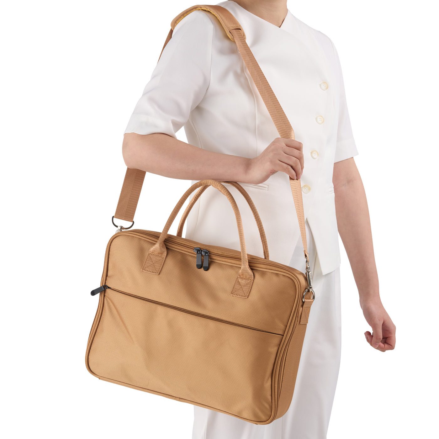 Person holding a brown hot stone heather bag against a white background