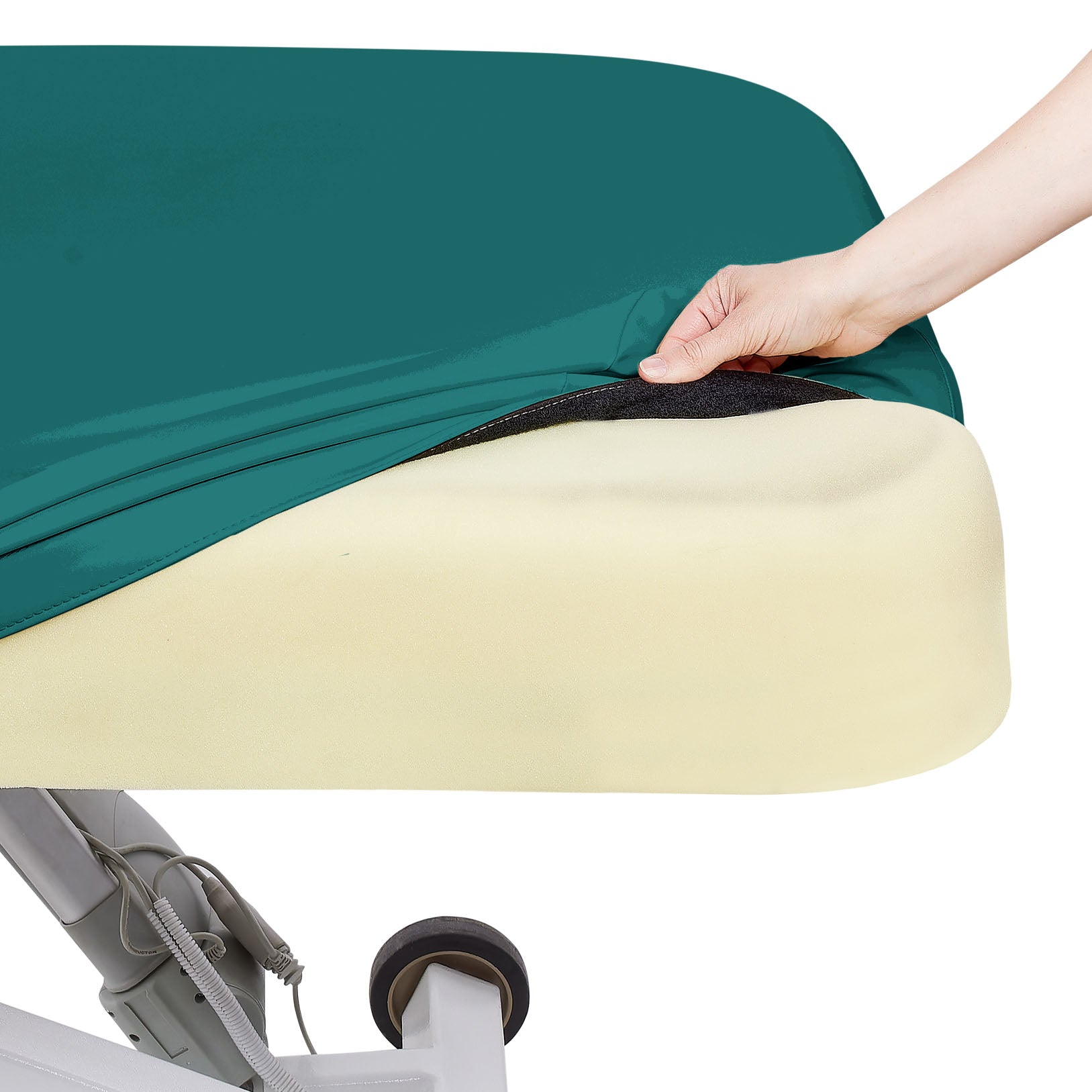A hand pulls back a teal sheet to reveal an EarthLite Ellora LX Tilt treatment table with mattress.