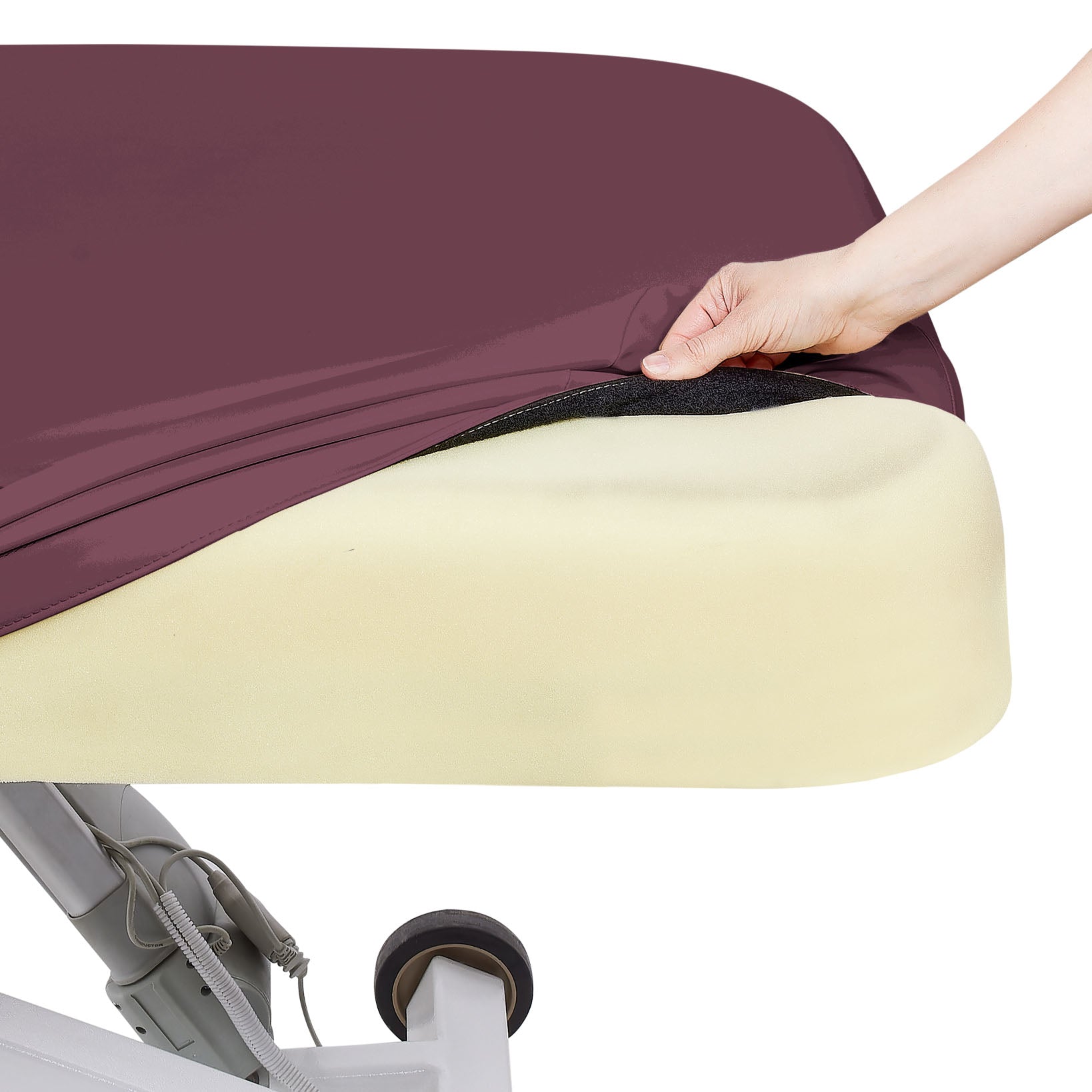 A hand lifts the cover to reveal Strata memory foam on the EarthLite Ellora LX treatment table.