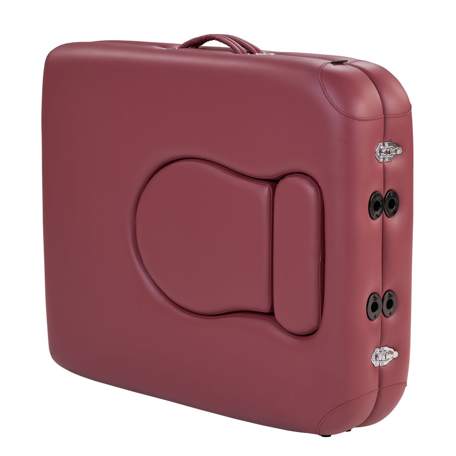 Closed Master Massage EVA PREGNANCY table, maroon, ergonomic, with handle, seen at an angle.