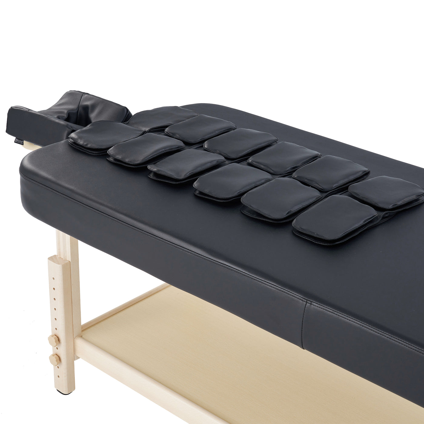 Black Master Massage AirMaster table with ten rectangular cushions for full body stretch.