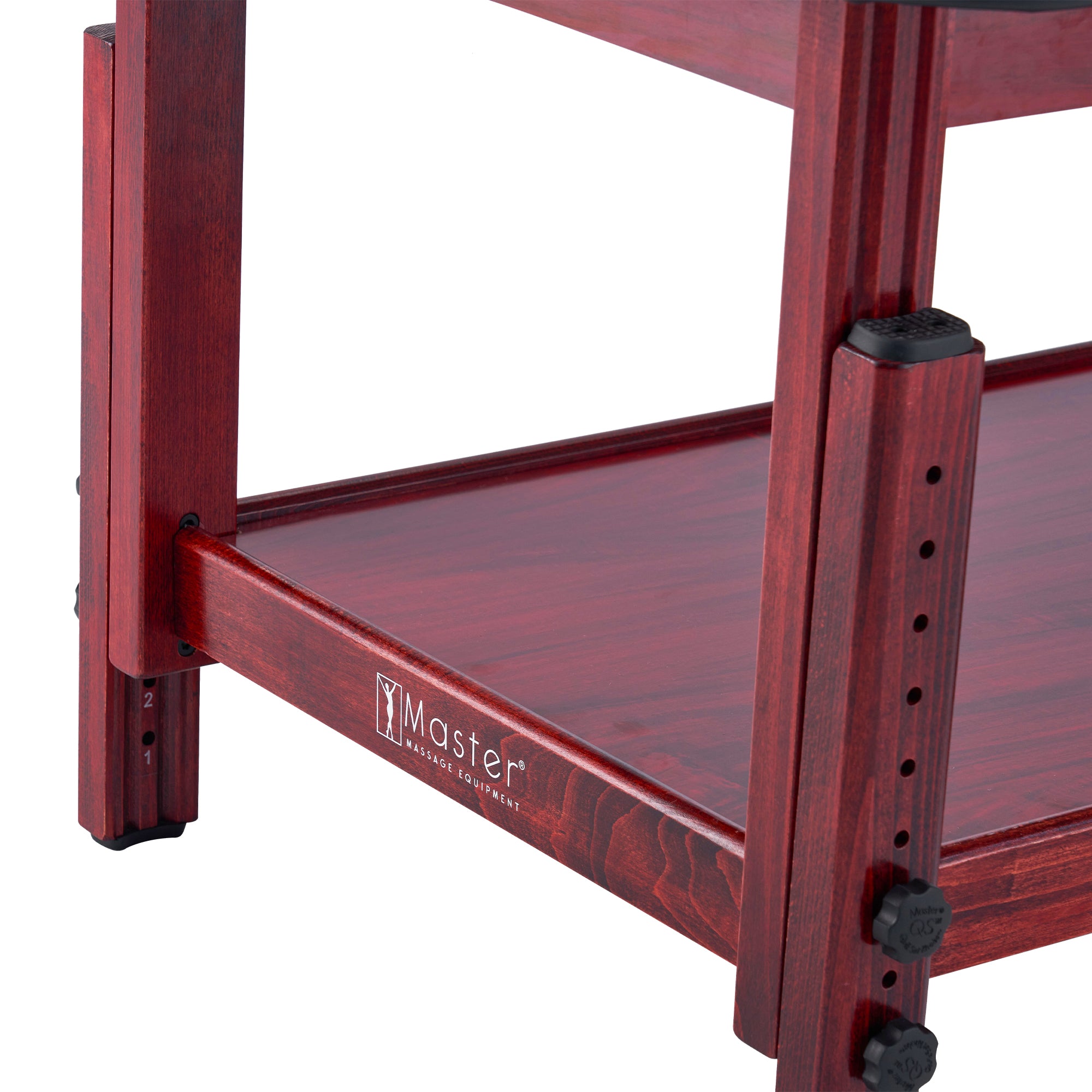 Close-up of a red shelf next to a Master Massage AirMaster Full Body Stretching Table.