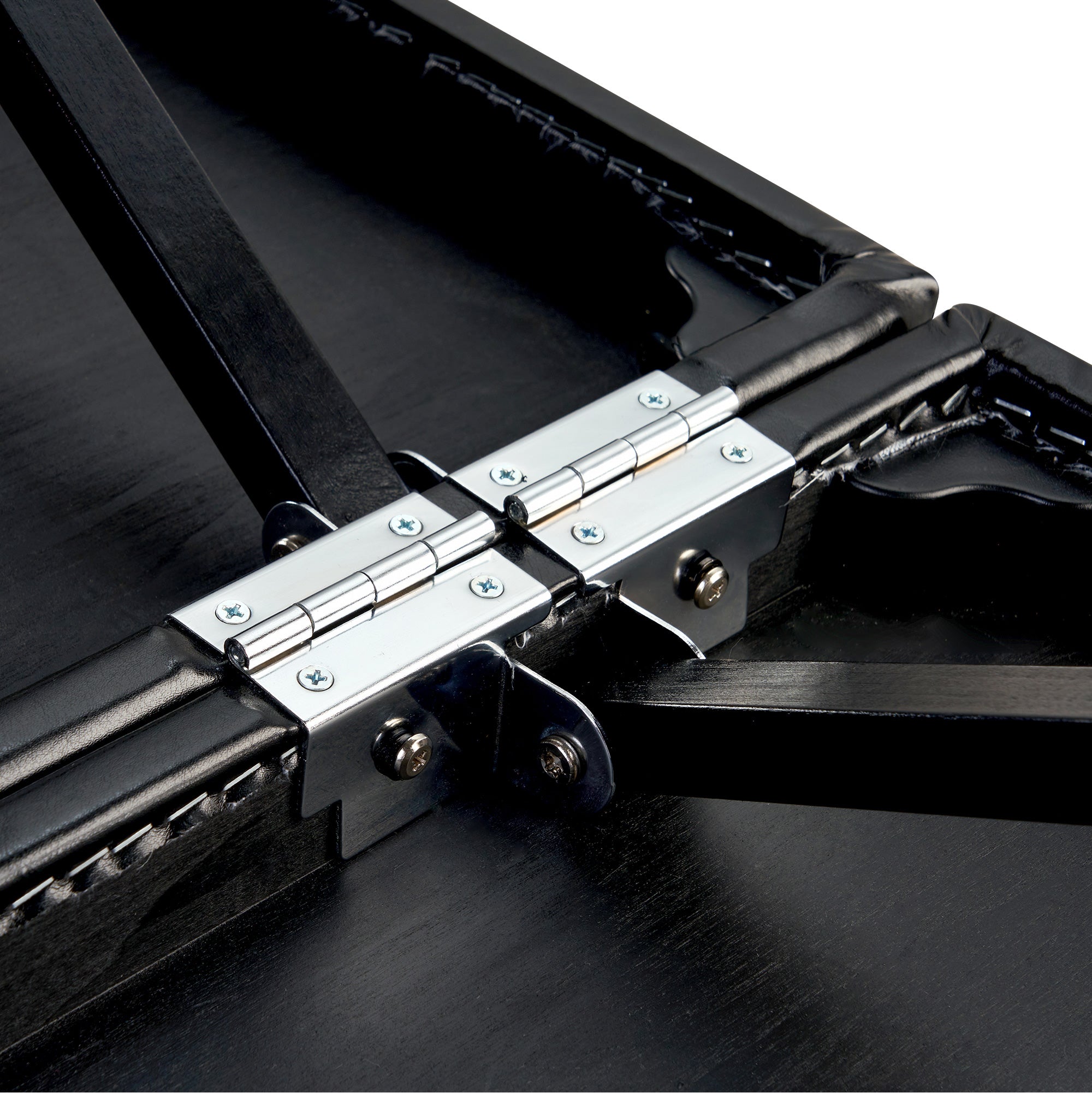Close-up of Master Massage MONACO Airwave table hinges, screws, and support bars on black panels.