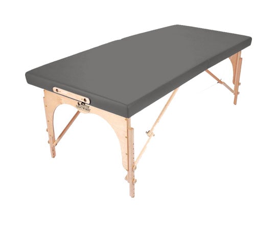 The Custom Craftworks ALEXANDER TECHNIQUE Table has a gray cushion and foldable wooden legs.