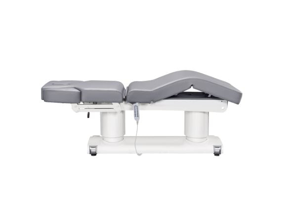 Luxi 4 Motors Medical Spa Treatment Table by DIR with gray cushioning and attached control device.