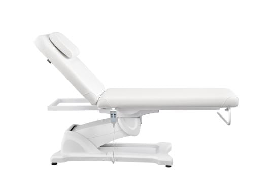 Serenity Electric Treatment Table by DIR, white with headrest, side view.