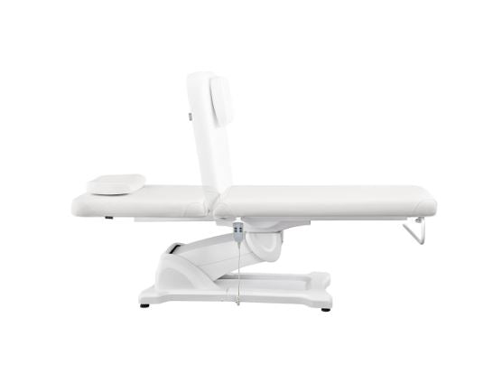 Serenity Electric Treatment Table by DIR, shown from the side with headrest attached.
