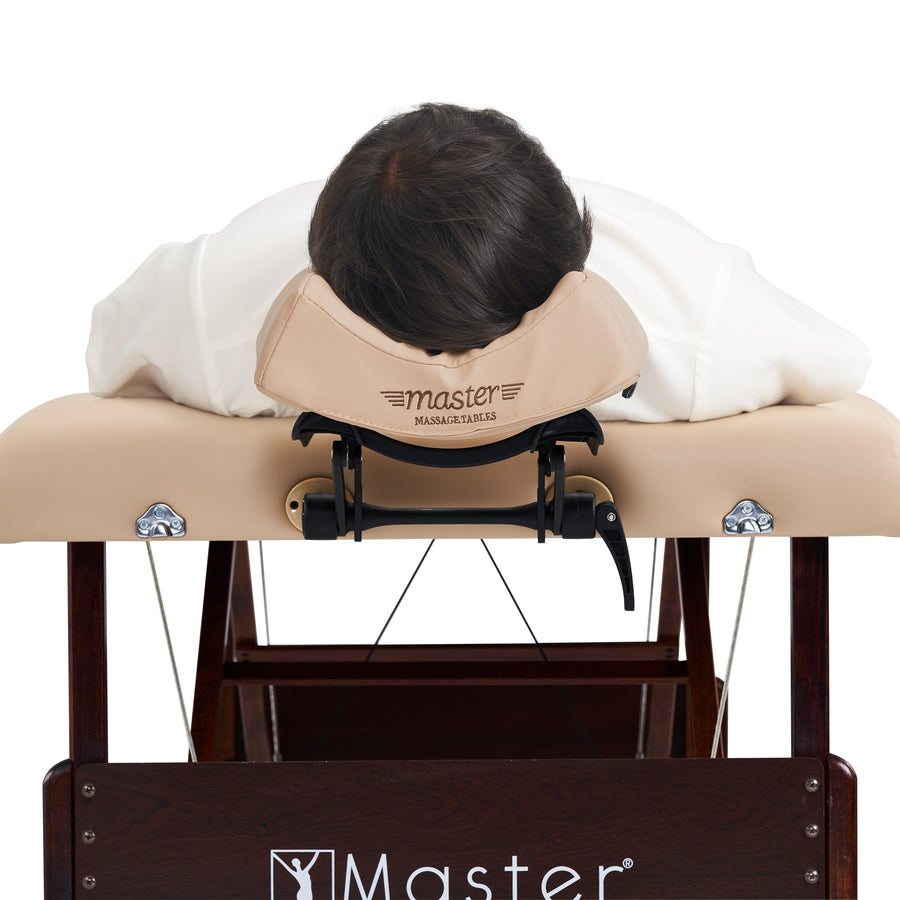 Person using a massage table with a headrest, branded 'Master Massage'.
