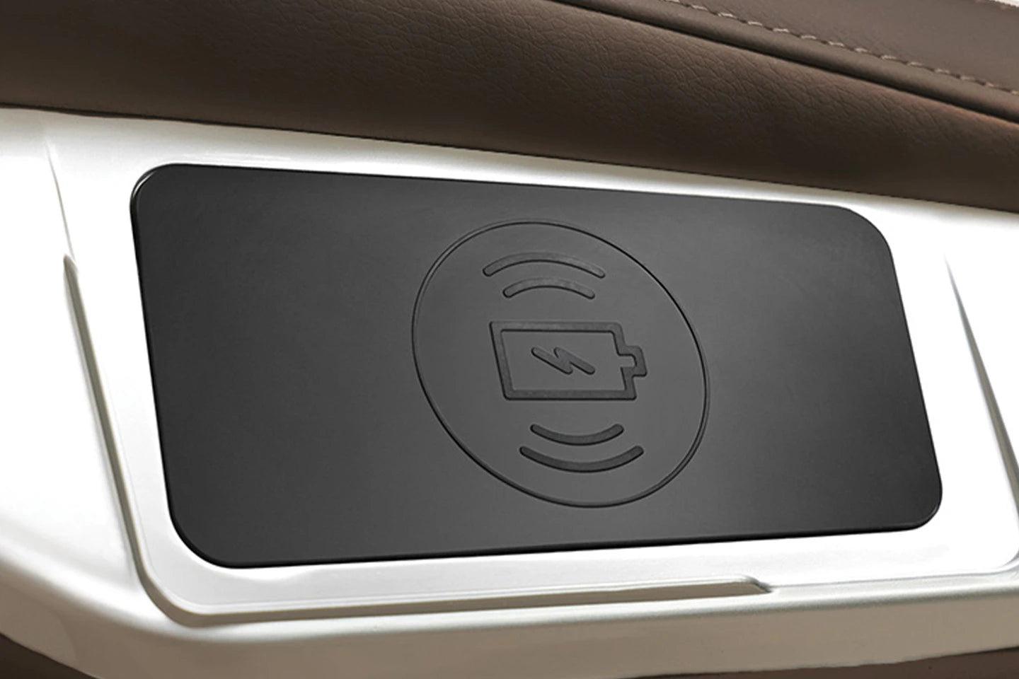 Close-up of Kyota Joubu M880 massage chair with built-in wireless phone charging pad.