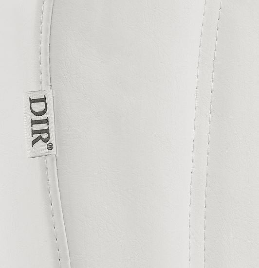 Close-up of white Libra II Medical Chair by DIR, featuring a DIR fabric tag on the upholstery seam.