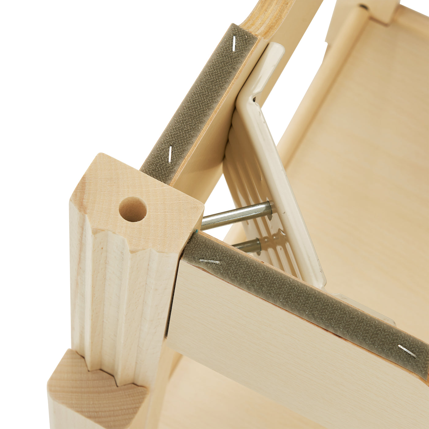 Close-up of MT Massage HARVEY TILT table frame underside with metal hardware and staples.