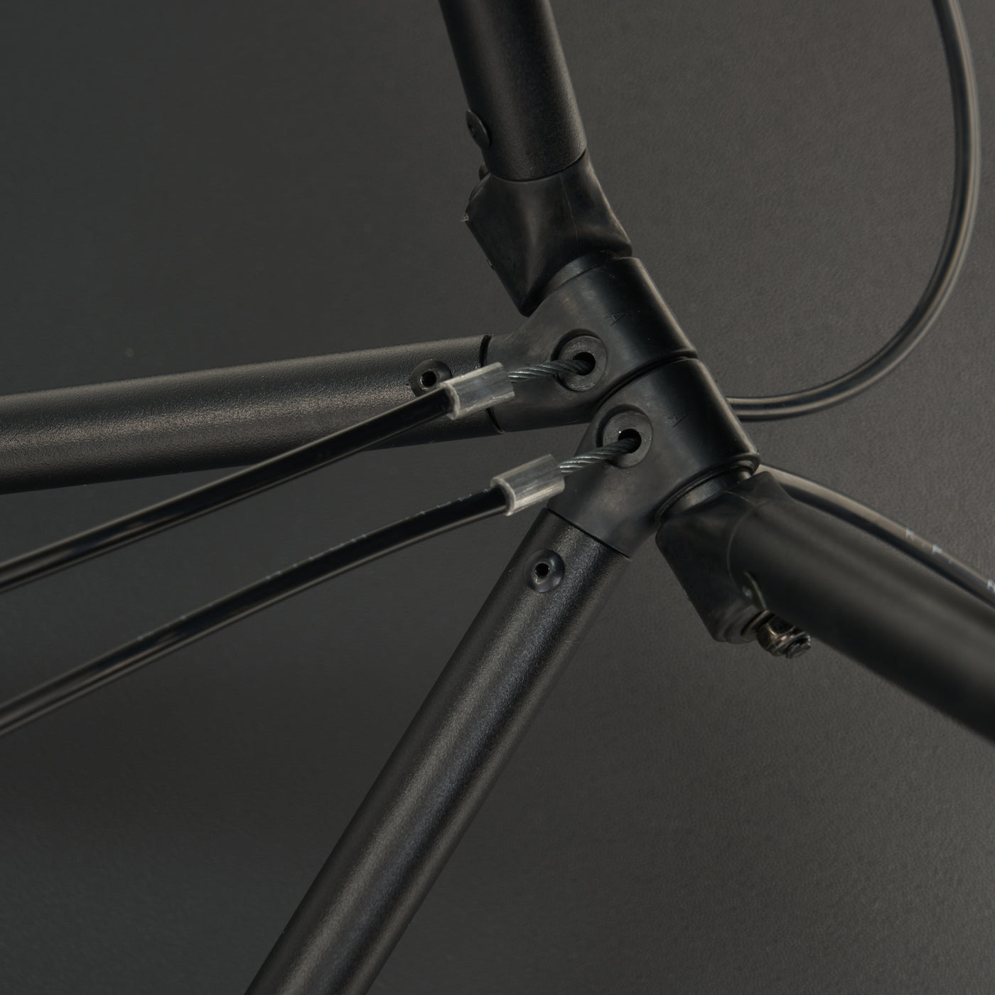 Close-up of a black bike frame with joints like the Master Massage MARS SPORT Treatment Table.