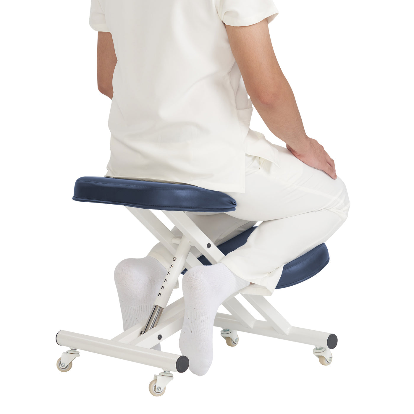 Person sitting on a blue and white adjustable stool with wheels on a white background