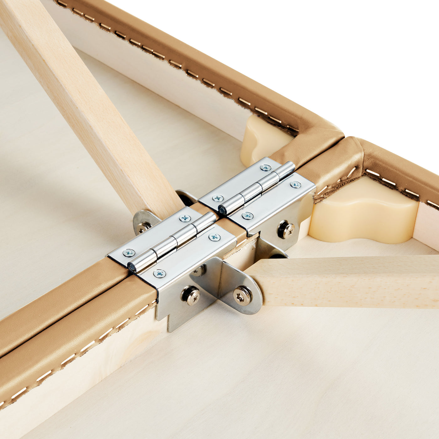 Close-up of metal hinges on the Master Massage PHOENIX Therma-Top Table’s wood frame and tan edges.