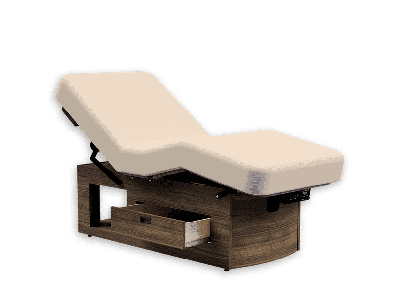 Oakworks Prema E-nvi electric spa table with beige cushion, wood base, and storage drawer.
