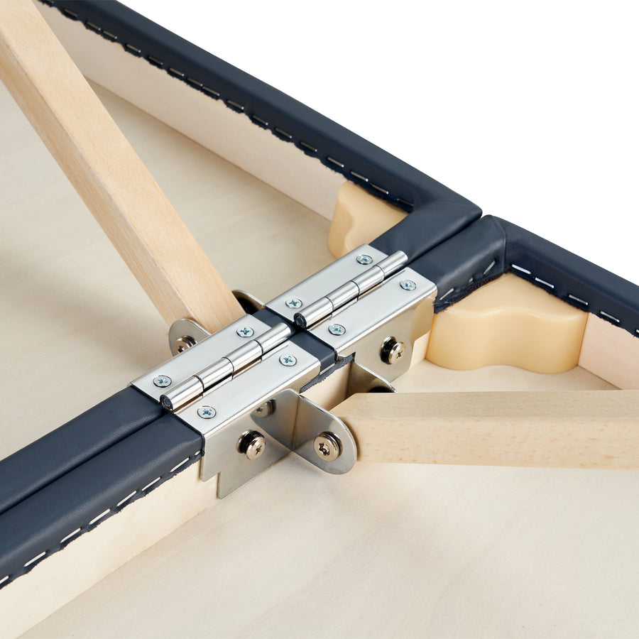 Close-up of a metal hinge on the Master Massage CORONADO Portable Massage Table connecting wood parts.