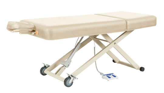 Beige hydraulic massage table on a white background
