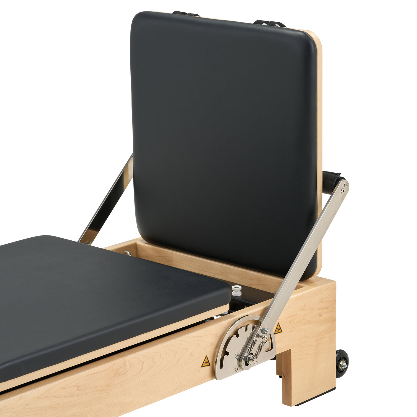 Pilates reformer with black cushioned surface on a white background