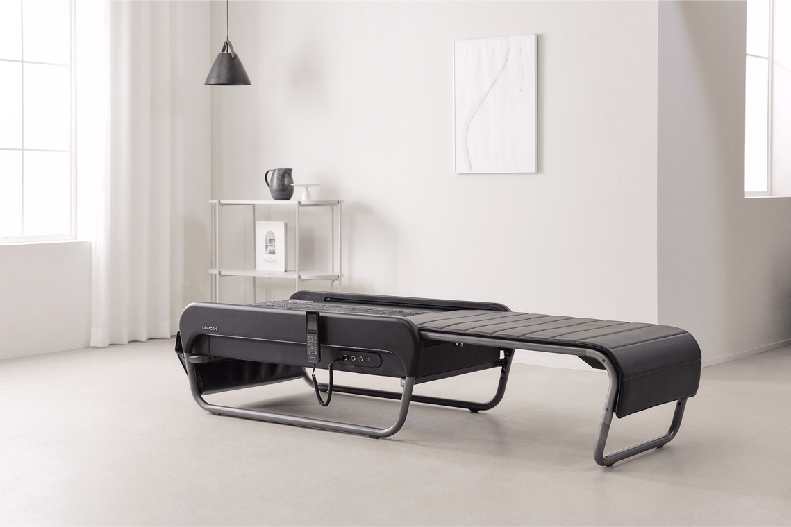 Ceragem Master V5 Therapeutic Massage Bed in a minimalistic room with white walls and light-colored floor.