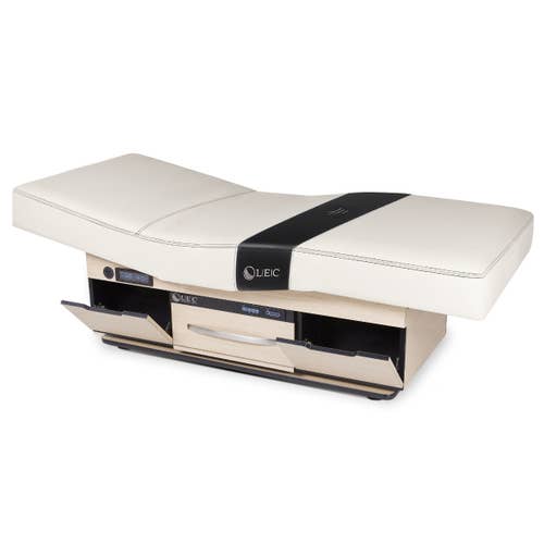 Living Earth Crafts CENTURY CITY treatment table with digital warming drawer and cream cushions.