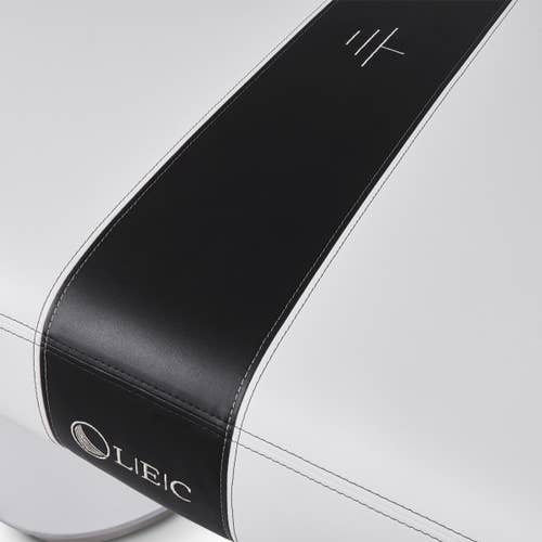 Detail of INSIGNIA 2.0 MODERN Table by Living Earth Crafts, with black stripe and white stitching.