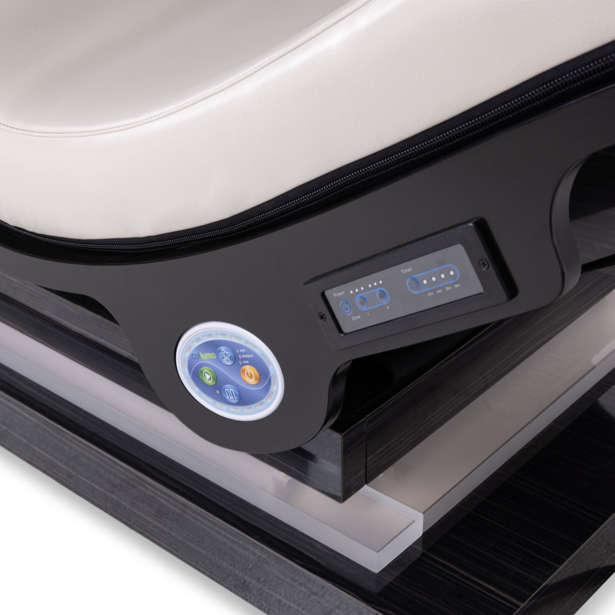 Close-up of Living Earth Crafts Longevity Reset Lounger showing the side control panel with a circular touch screen and a digital display, set against a black frame and a cream-colored padded seat.