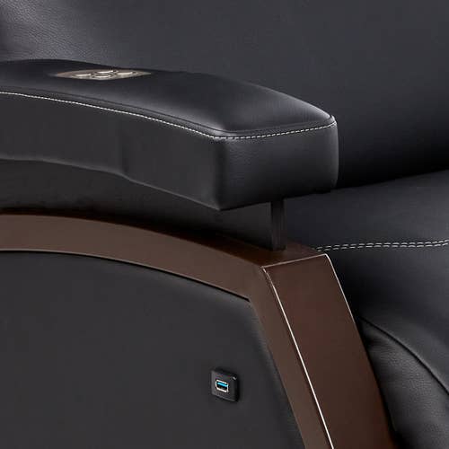 Close-up of Living Earth Crafts Mind-Sync 2.0™ Lounger armrest with USB port and stitching detail.