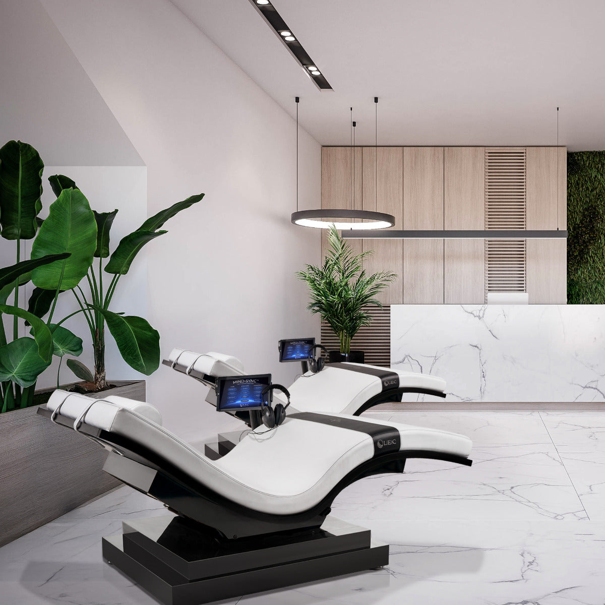 Living Earth Crafts Mind-Sync Reset™ Lounger w/ IceBlock™ Chromatherapy base with built-in screens, set in a contemporary wellness room with marble floors, large green plants, and light wood cabinetry.