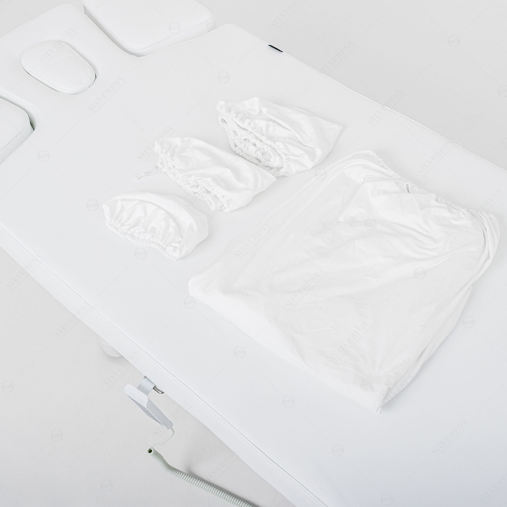 Silverfox America OCILI 2249 Electric Massage Table with white fitted sheet for spa comfort.