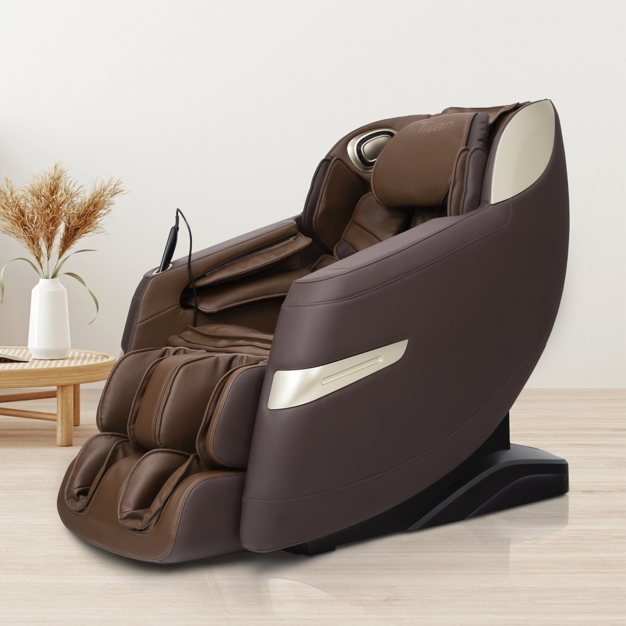 Titan 3D Quantum Electric Massage Chair by Titan in a modern room with light floors and side table.