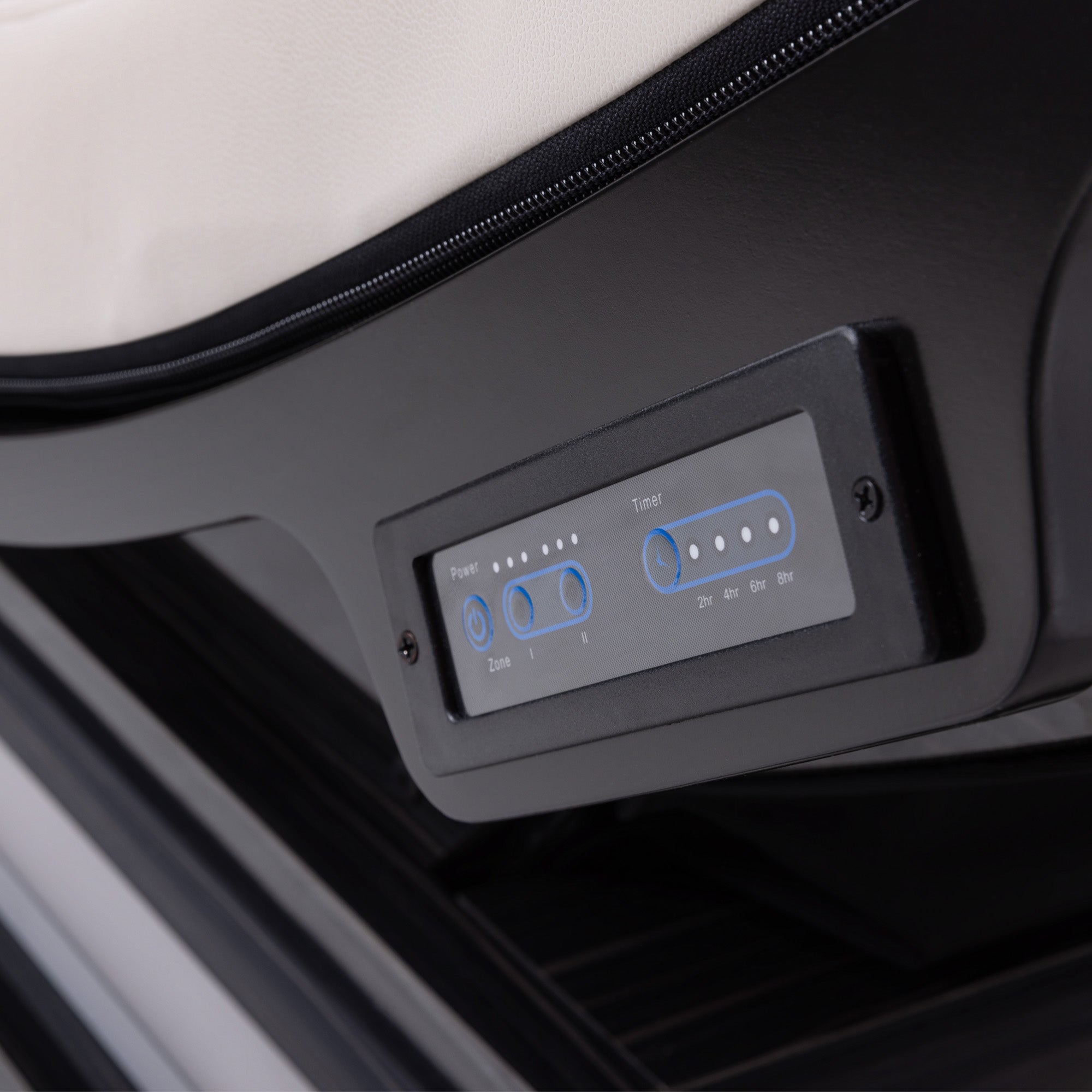 Close-up of a black electronic control panel with blue-lit buttons