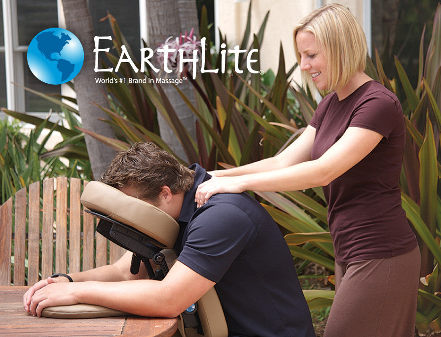 A woman gives a man an outdoor massage with the EarthLite TRAVELMATE Portable Massage System.