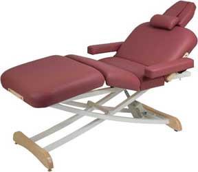 Custom Craftworks ELEGANCE DELUXE maroon lift table with head support and padded armrests.