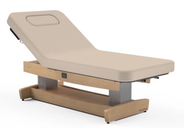 Oakworks PERFORMALIFT spa table with wooden base and face cradle for ultimate comfort.