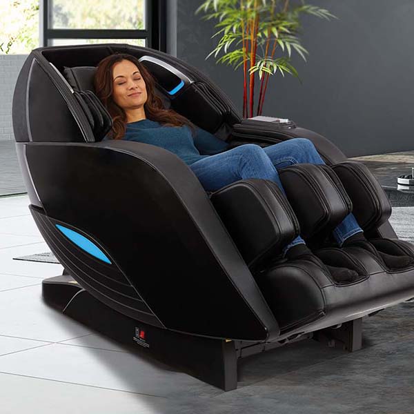 Woman unwinds in a Kyota Yutaka M898 4D Massage Chair (Certified Preowned) in a sunny room.