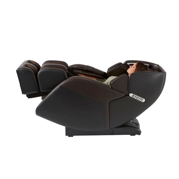 Woman relaxing in a Kyota M673 Kenko 3D/4D massage chair, legs up, eyes closed.