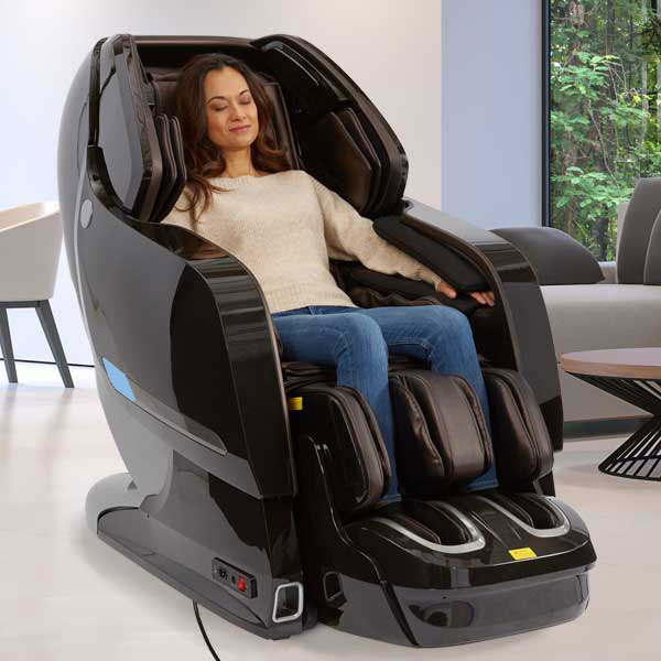 Woman relaxing in a Kyota YOSEI M868 4D Electric Massage Chair with foot reflexology.