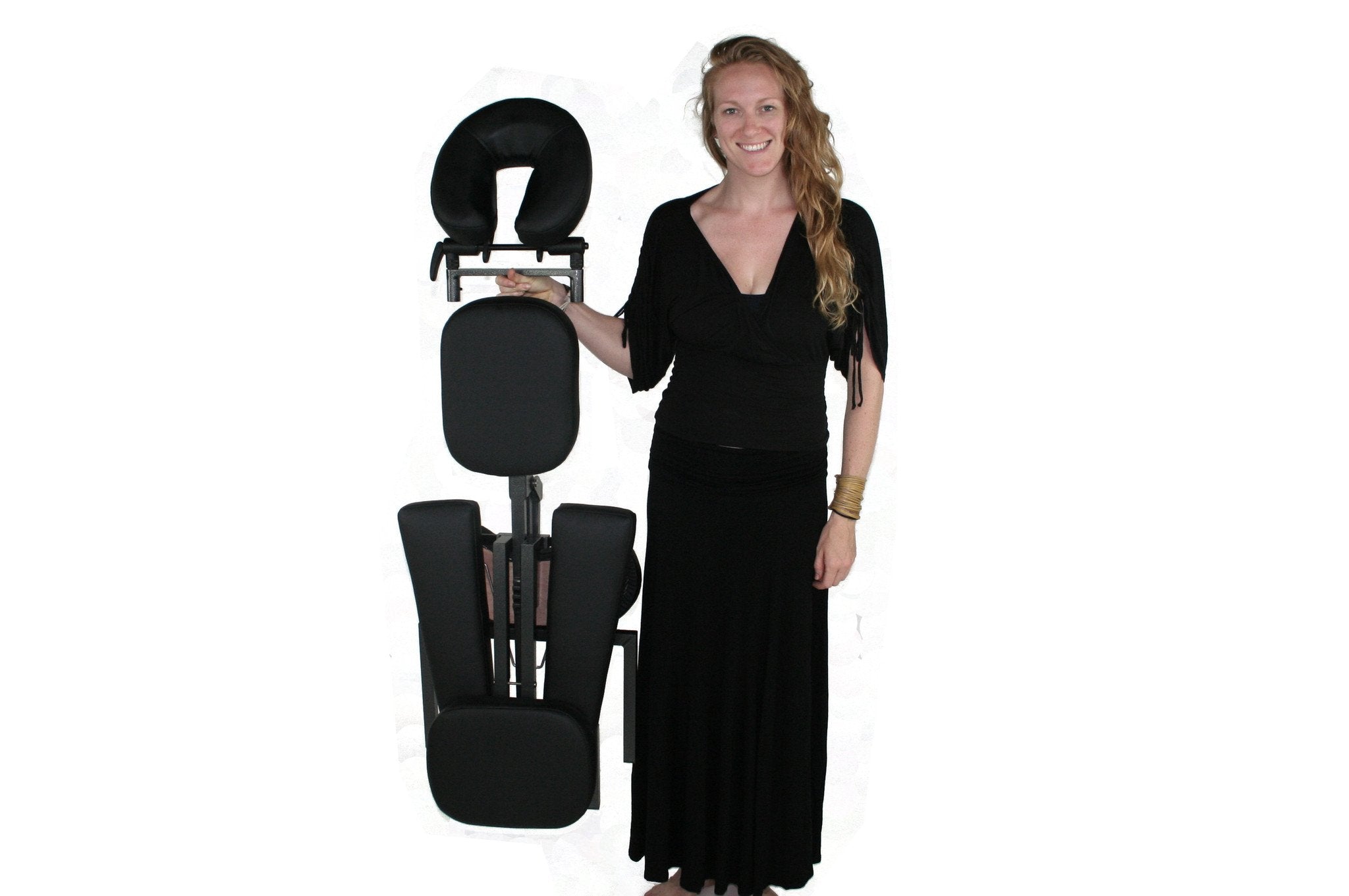Woman stands next to TouchAmerica QUICKLITE Massage Chair against a white background.