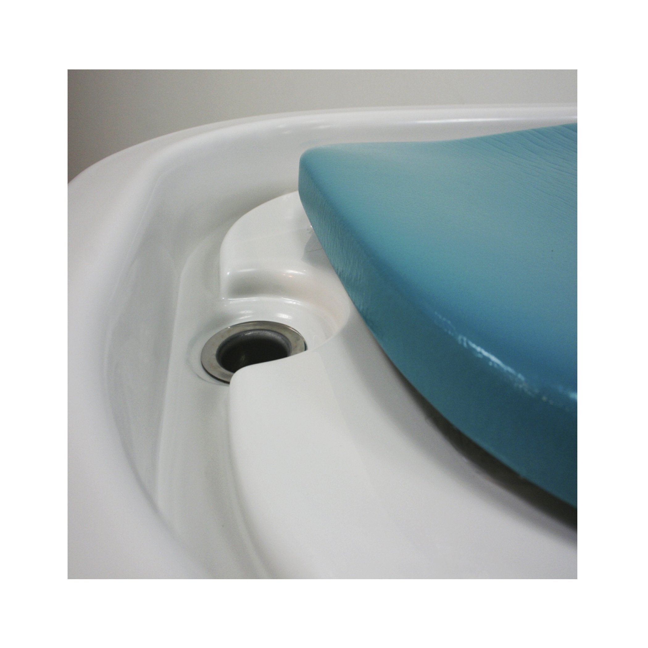 Close-up of a blue chair beside a TouchAmerica Neptune Battery Wet Table in a white basin.