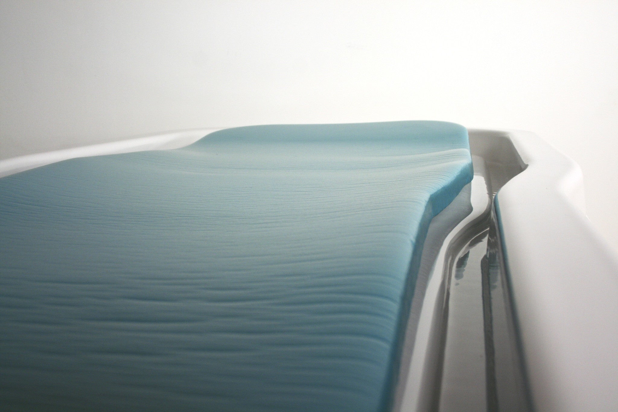 TouchAmerica STATIONARY NEPTUNE/VICHY Shower Package beside a sleek hydrotherapy table.