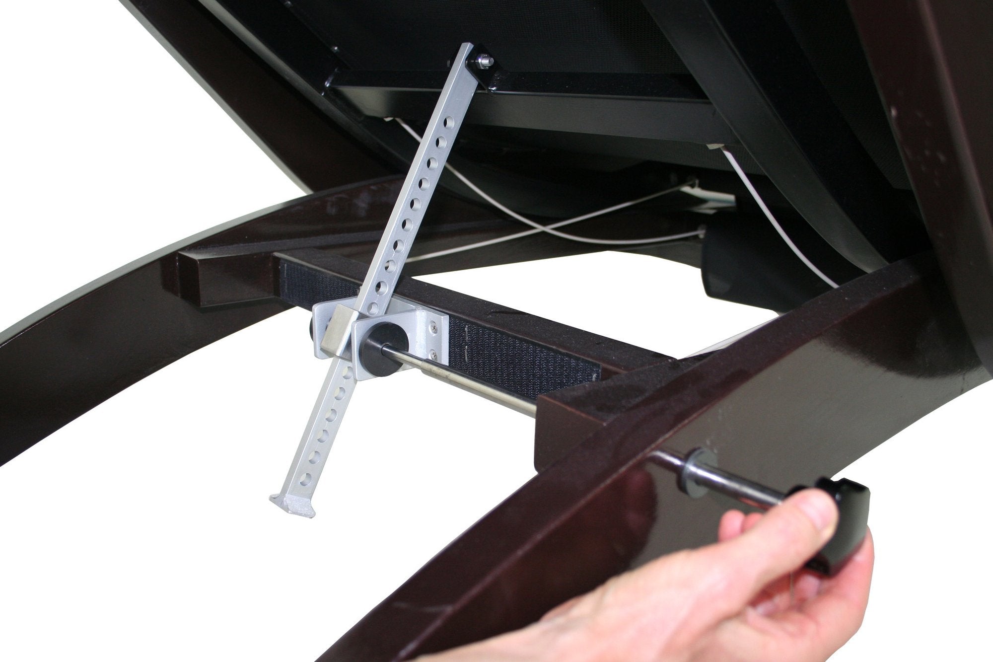 Adjusting a screw on the TouchAmerica BREATH Pedi-Lounge spa furniture with dark wood frame.