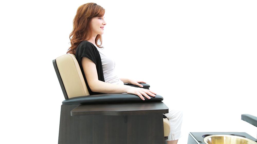 Woman in Comfort Soul ALPINA Pedicure Client Chair Set with UltraPlush cushioning, white background.