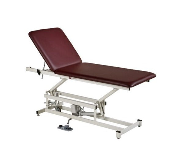 Armedica AM-227 maroon adjustable treatment table with metal frame and foot pedal controls.