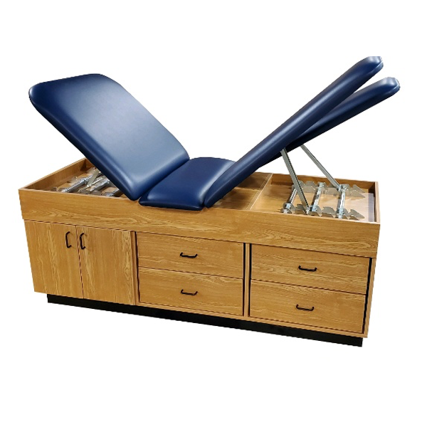 Adjustable exam table with blue cushions and PHS Medical CAB-150 Treatment Cabinet storage.