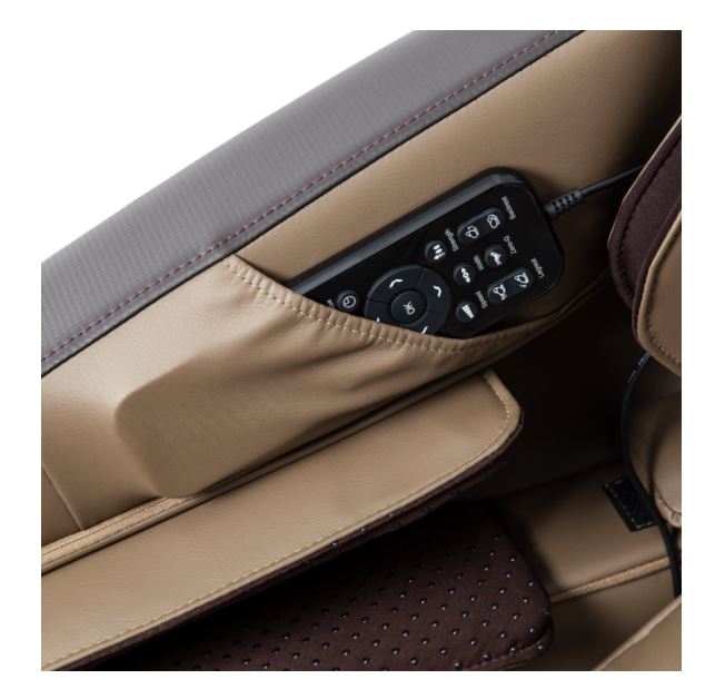 A black remote in the side pocket of a Titan PRO COMMANDER brown leather 3D massage chair.