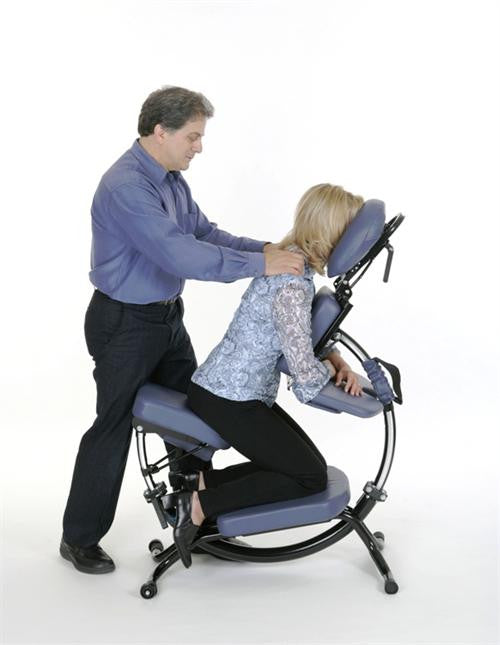 A person on a Pisces Pro DOLPHIN II Massage Chair gets a shoulder massage from someone standing.