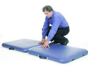 Man kneeling on two Pisces Pro NEW WAVE II Lite Portable Massage Table cushions side by side.