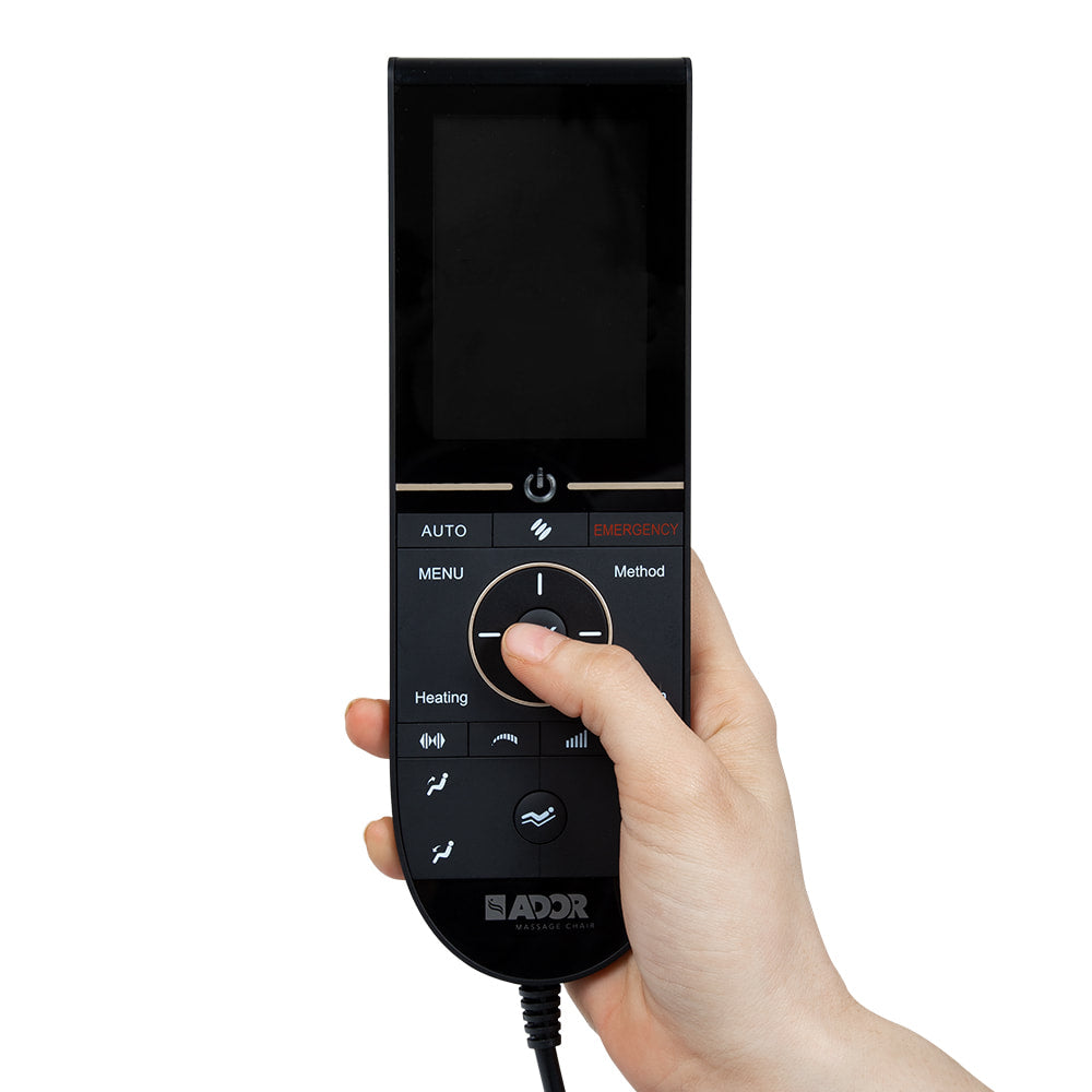 A hand operates a black Ador AD-Infinix massage chair remote with screen and buttons.