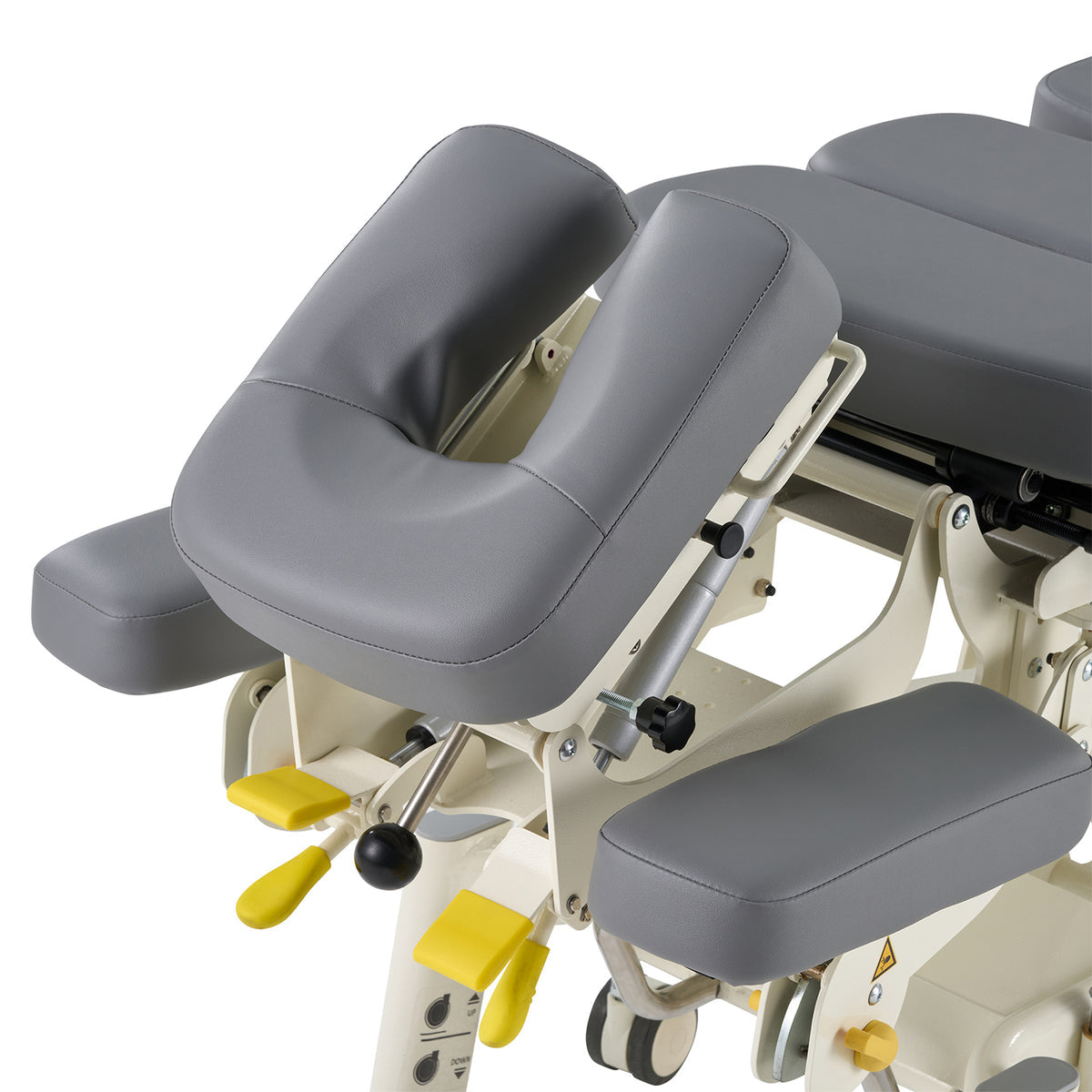 Gray medical examination table with adjustable parts on a white background