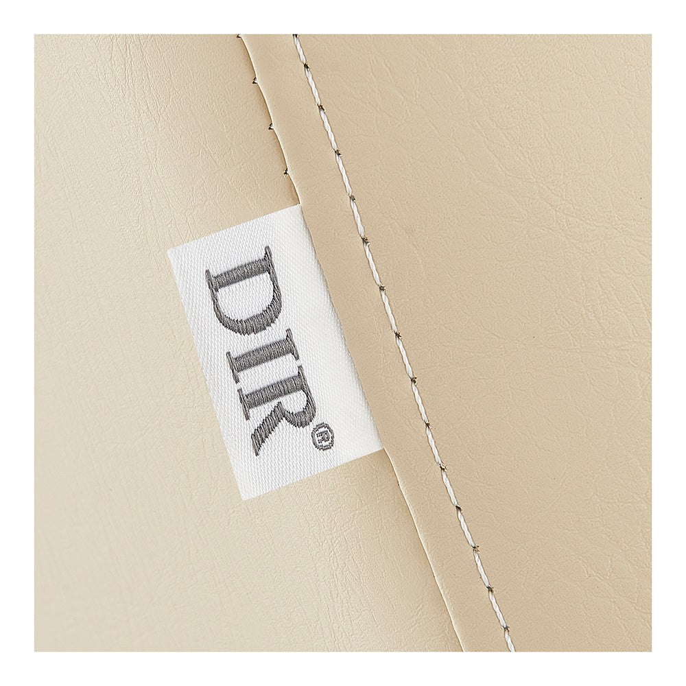 Close-up of the Serenity Electric Treatment Table DIR's stitched seam and DIR tag.